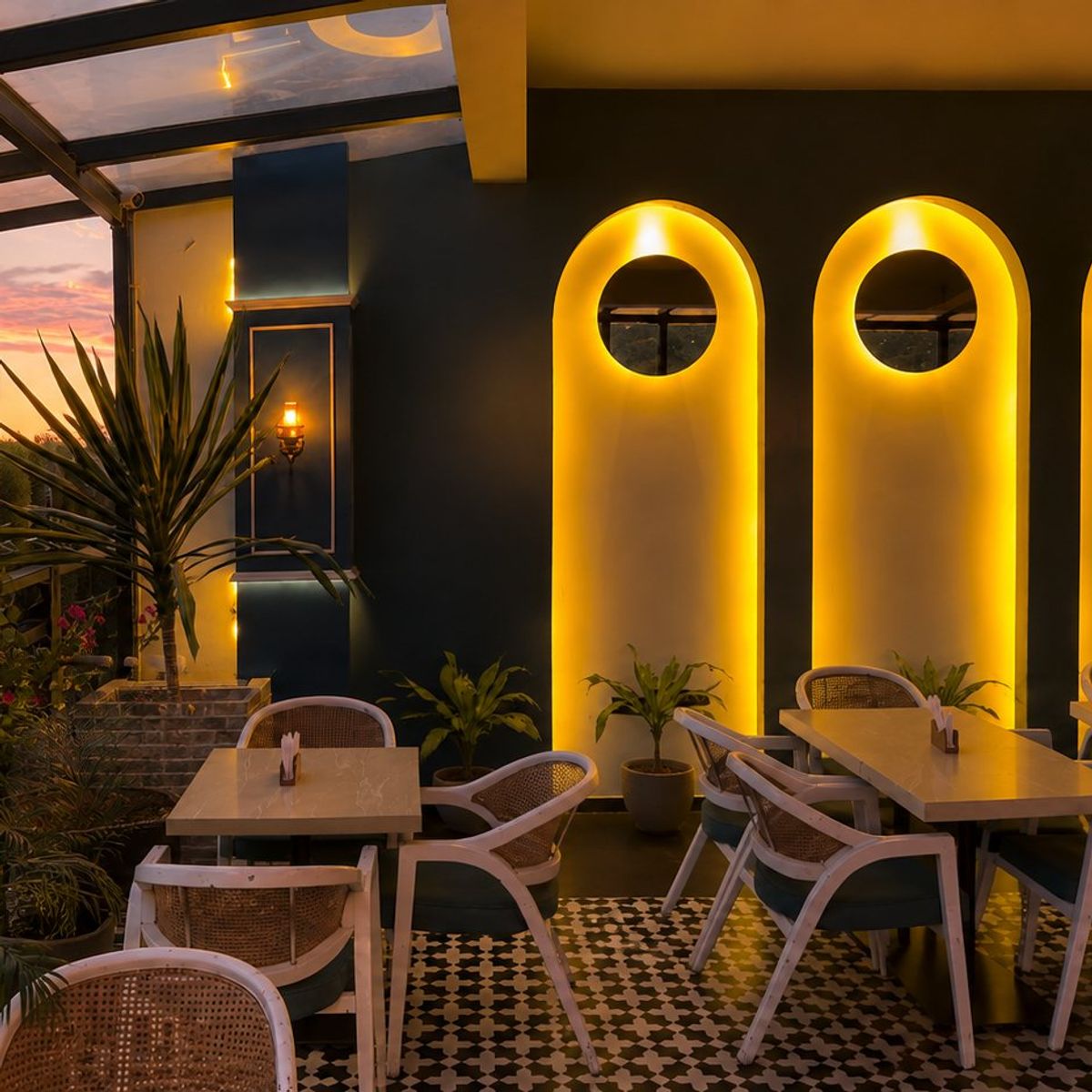 The garden corner — lit arches and greenery