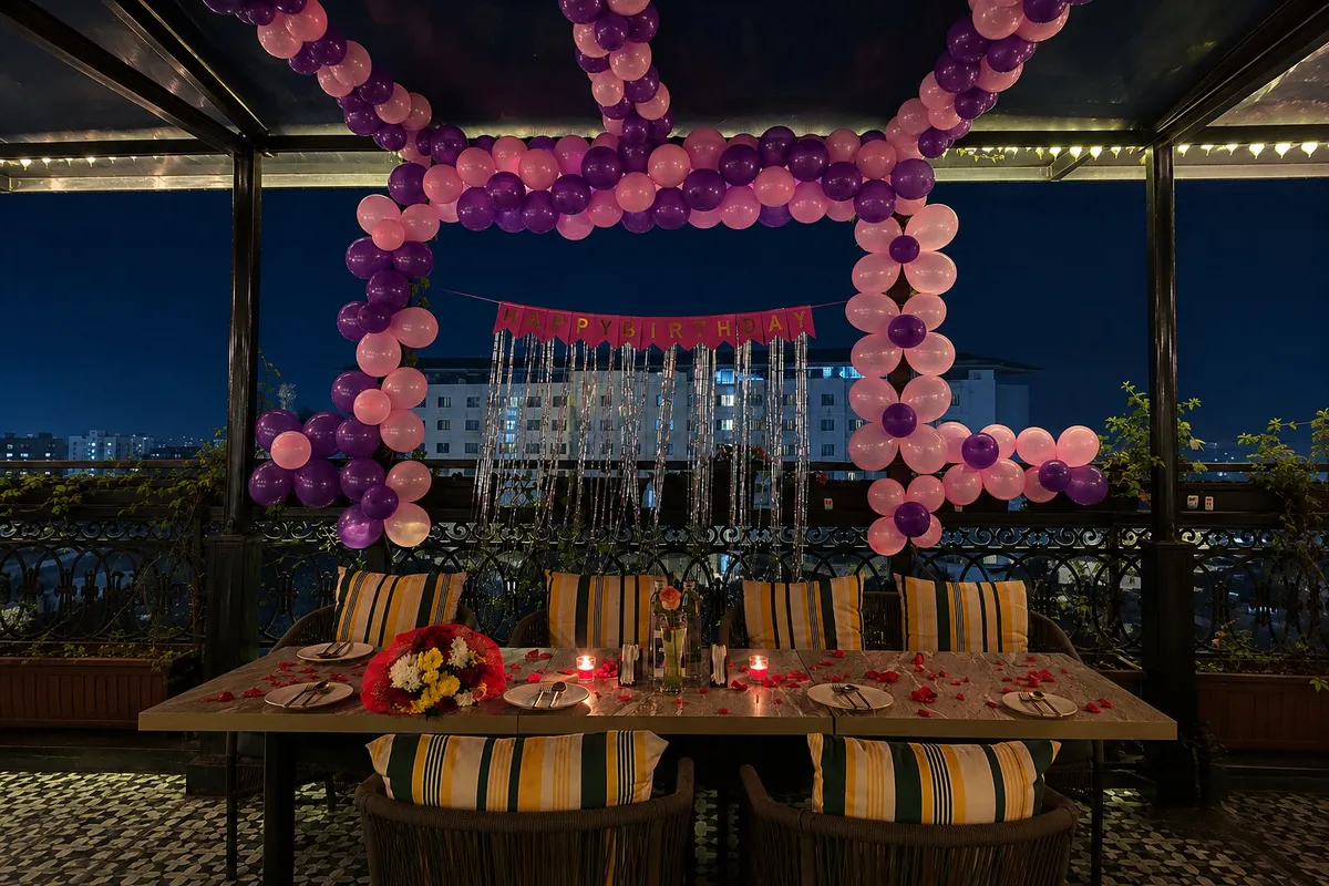 Premium décor — a long celebration table under a balloon canopy